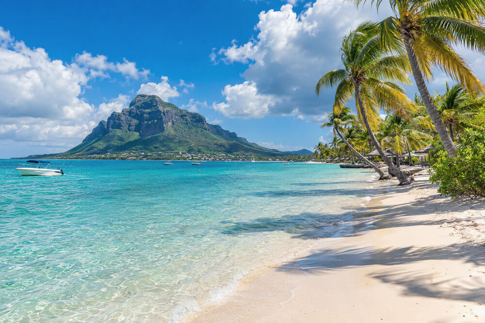 Piaszczysta plaża i zielona góra nad laguną Mauritiusa